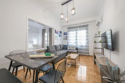 a living room with a table and a couch at Athens Bright Suite by CloudKeys in Athens