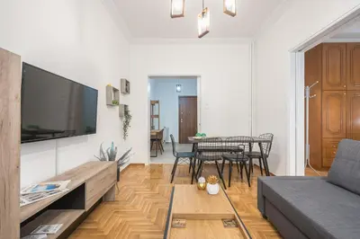a living room with a couch and a table at Athens Bright Suite by CloudKeys in Athens