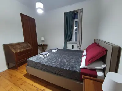a small bedroom with a bed and a window at AcroView in Athens
