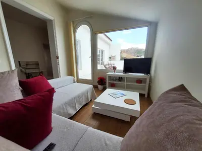 a living room with two couches and a tv at AcroView in Athens