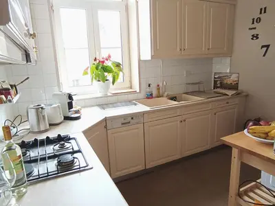 a kitchen with white cabinets and a stove top oven at AcroView in Athens