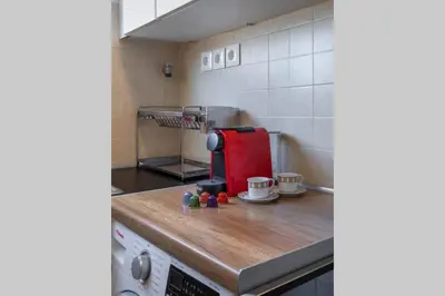 a kitchen with a red appliance on a wooden counter at Four Seasons Sea View Apartment in Athens