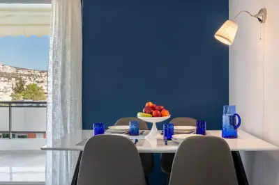 a dining room table with a bowl of fruit on it at Four Seasons Sea View Apartment in Athens