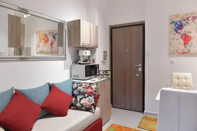 a small kitchen with a couch and a microwave at Asklipiou New Smart Mondern Central Studio in Athens