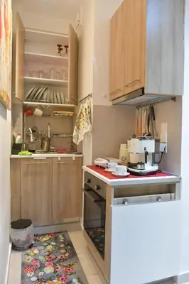 a kitchen with wooden cabinets and a stove top oven at Asklipiou New Smart Mondern Central Studio in Athens
