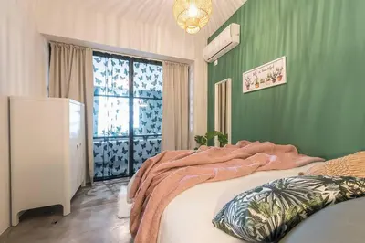 a bedroom with green walls and a large bed at The Boutique in Athens