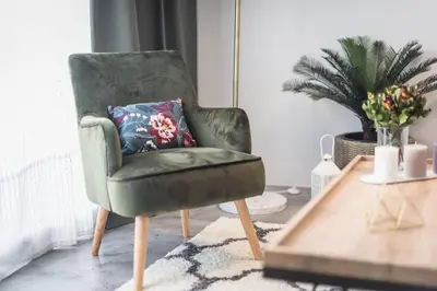 a green chair with a pillow in a living room at The Boutique in Athens