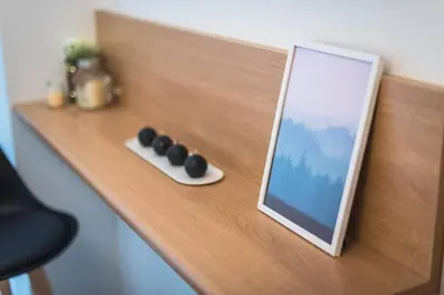 a picture frame sitting on top of a wooden shelf at The Boutique in Athens