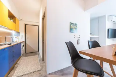 a kitchen with a dining room table and chairs at The Boutique in Athens