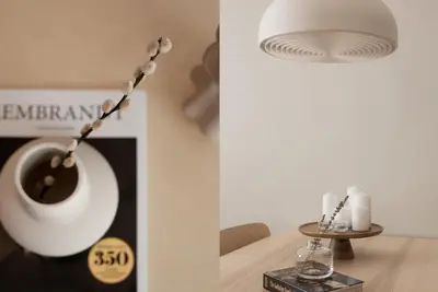a living room with a white vase and a table at Absolute 2BR Apartment near EMST Museum by UPSTREET in Athens