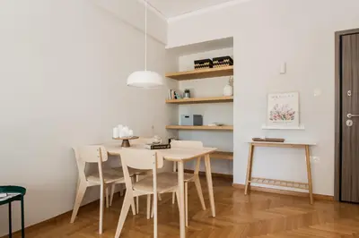 a dining room with a table and chairs at Absolute 2BR Apartment near EMST Museum by UPSTREET in Athens