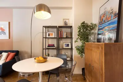 a living room with a table and a shelf at Marina Zeas apartment by the sea in Piraeus