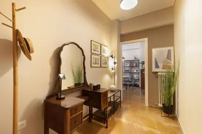 a hallway with a dressing table and a mirror at Marina Zeas apartment by the sea in Piraeus