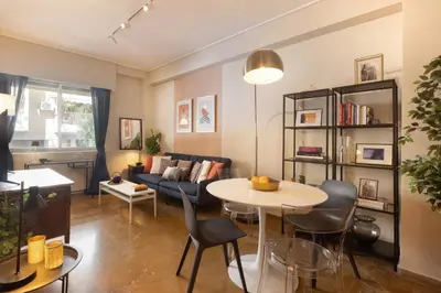 a living room with a couch and a table at Marina Zeas apartment by the sea in Piraeus