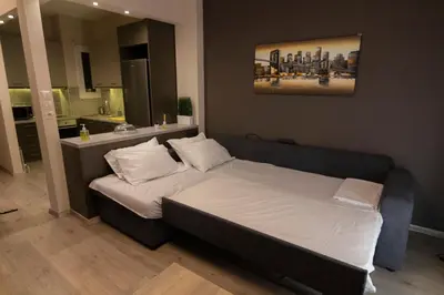 a bedroom with a bed and a bathroom with a sink at Luxury apartment 10’ from the center! in Athens