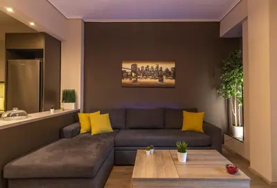 a living room with a couch and a table at Luxury apartment 10’ from the center! in Athens