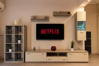 a living room with a netflix sign on the wall at Luxury apartment 10’ from the center! in Athens