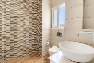 a bathroom with a white tub and a sink at Acropolis Royal Suite in Athens