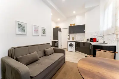 a living room with a couch and a table at Acropolis Royal Suite in Athens