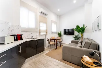 a kitchen and living room with a couch and a table at Acropolis Royal Suite in Athens