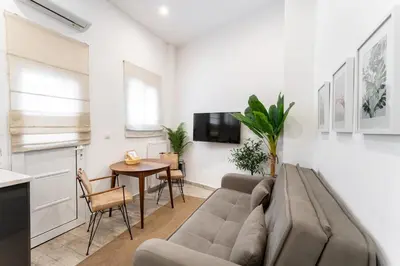 a living room with a couch and a table at Acropolis Royal Suite in Athens