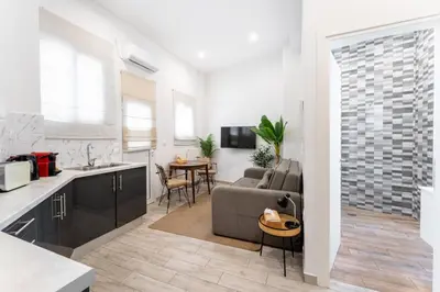 a kitchen and living room with a couch and a table at Acropolis Royal Suite in Athens