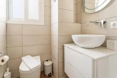 a bathroom with a sink and a toilet at Acropolis Royal Suite in Athens