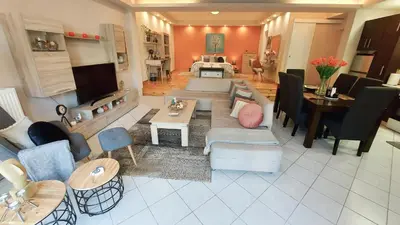 a large living room with a couch and a table at Unique, Stylish Studio near Beaches in Athens