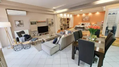 a living room with a couch and a table at Unique, Stylish Studio near Beaches in Athens
