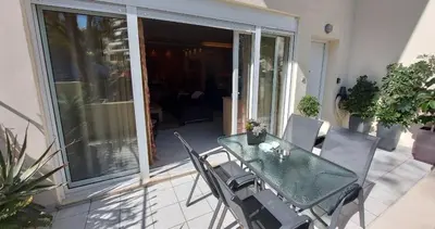 a glass table and chairs on a patio at Unique, Stylish Studio near Beaches in Athens