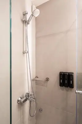 a shower in a bathroom with a glass door at Bright, Cosy Studio close to Glyfada Beach & Center in Athens