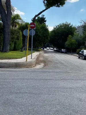 a stop sign on the side of a street at Bright, Cosy Studio close to Glyfada Beach & Center in Athens