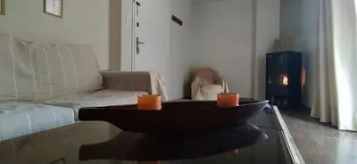a living room with a couch and a coffee table at Experience the sweetest nest at Marina Zea in Piraeus