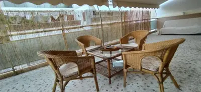 a group of chairs and a table in a room at Experience the sweetest nest at Marina Zea in Piraeus