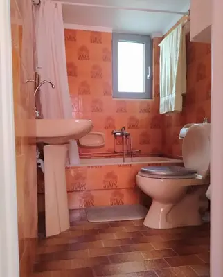 a bathroom with a toilet and a sink at Experience the sweetest nest at Marina Zea in Piraeus