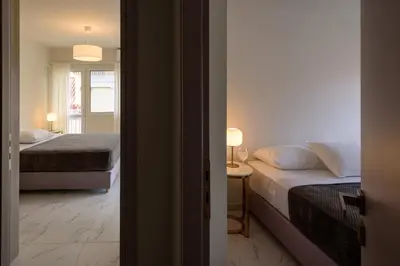 a small bedroom with two beds and a window at ERMOU STREET APARTMENTs in Athens