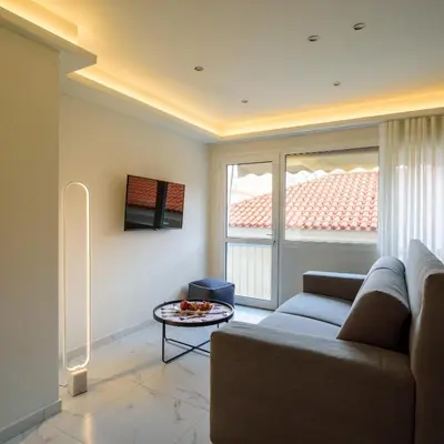 a living room with a couch and a table at ERMOU STREET APARTMENTs in Athens