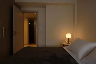 a bedroom with a bed and a lamp on a table at ERMOU STREET APARTMENTs in Athens