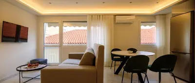 a living room with a couch and a table at ERMOU STREET APARTMENTs in Athens