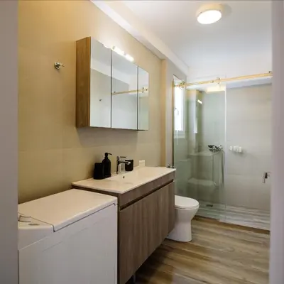 a bathroom with a sink and a toilet and a shower at ERMOU STREET APARTMENTs in Athens