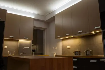 a kitchen with brown cabinets and a counter top at It is a pleasant, modern, functional house! in Piraeus