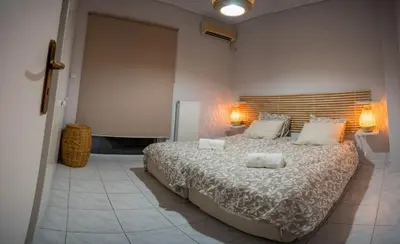 a bedroom with a large bed with two towels on it at It is a pleasant, modern, functional house! in Piraeus