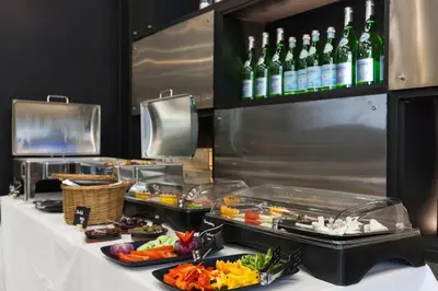 a buffet line with food and bottles of wine at Trendy Hotel by Athens Prime Hotels in Athens