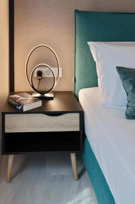 a side table with a mirror on it next to a bed at Trendy Hotel by Athens Prime Hotels in Athens