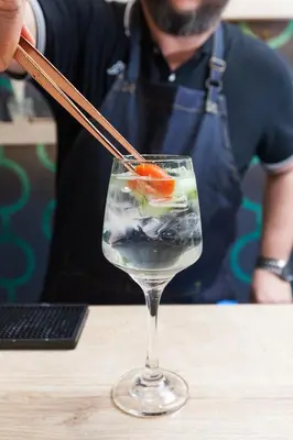 a person holding a chopstick in a wine glass at Trendy Hotel by Athens Prime Hotels in Athens