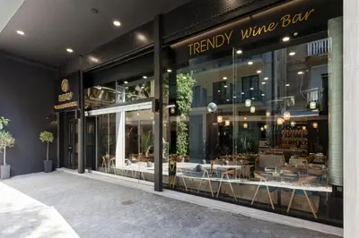a therapy wing bar with tables and chairs in the window at Trendy Hotel by Athens Prime Hotels in Athens
