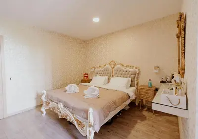 a bedroom with a white bed and a sink at ROH Suites in Athens