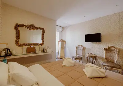 a bedroom with a large bed and a mirror at ROH Suites in Athens