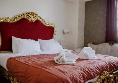 a bed with white towels on top of it at ROH Suites in Athens