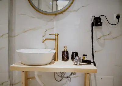 a bathroom with a sink and a mirror at ROH Suites in Athens